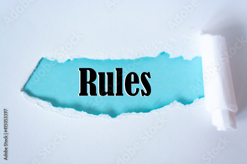 The word rules appearing behind torn paper