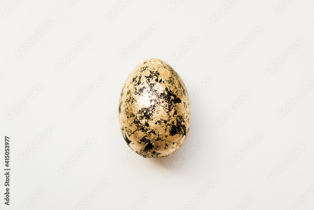 Easter decorated with golden potal egg isolated on white background. Minimal easter concept. Happy Easter card with copy space for text. Top view, flatlay. Concept for banner, flyer, invitation Easter decorated with golden potal egg isolated on white background. Minimal easter concept. Happy Easter card with copy space for text. Top view, flatlay. Concept for banner, flyer, invitation