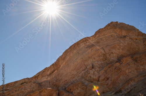 sun burst on the top of Vasquez Rocks photo