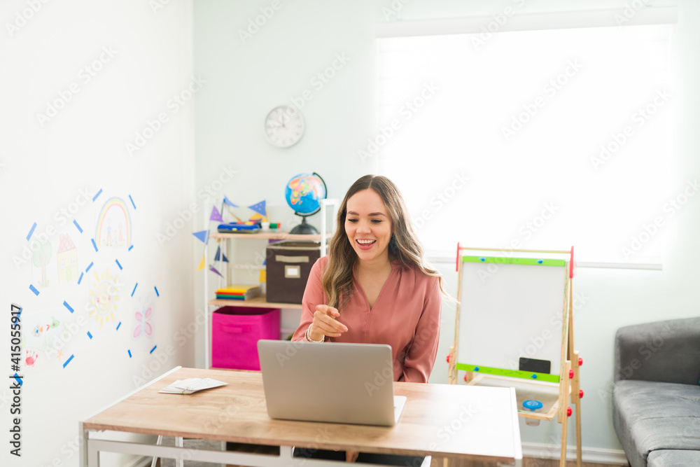 Preschool teacher speaking to her students in an online class Preschool teacher speaking to her students in an online class