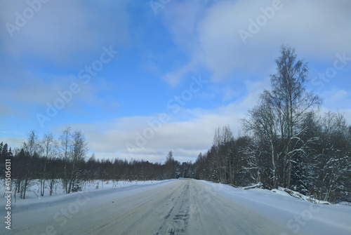 road with horizon on blue sky and clouds in the daytime at winter with snow covered trees © Левон Мартиросян