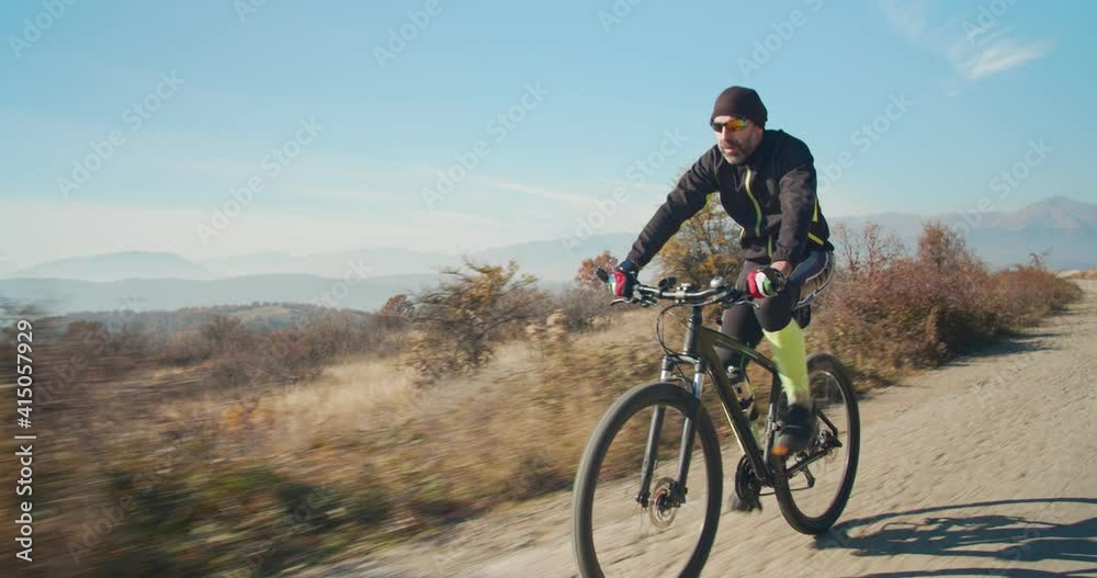 Man bicycling in the hills Man bicycling in the hills
