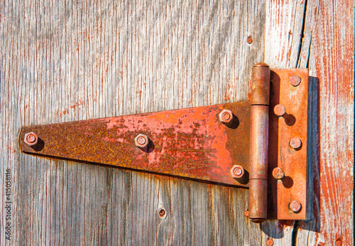 rusted tee hinge on a barn