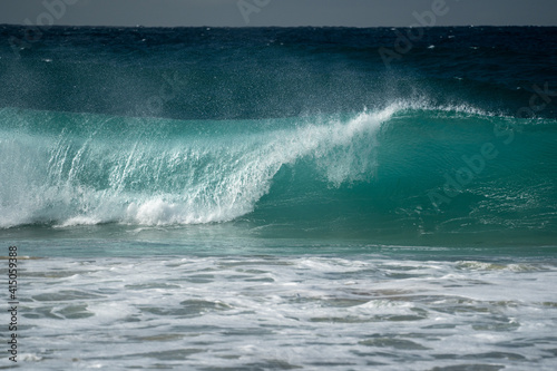 Fototapeta Naklejka Na Ścianę i Meble -  A beautiful perfect wave breaking on the coast