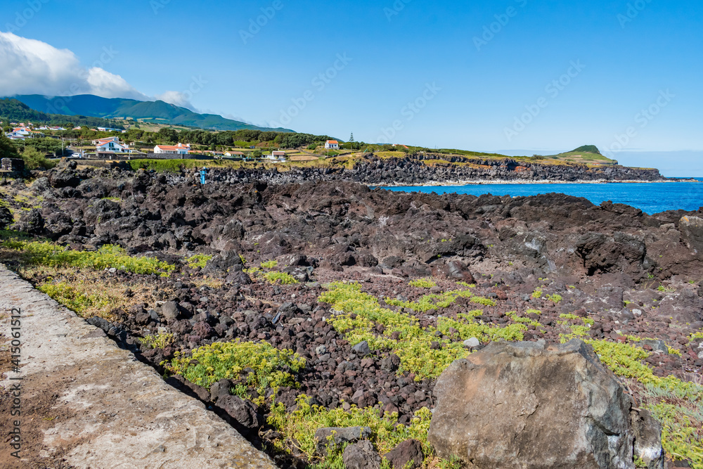Geological zone with volcanic stones next to the sea and mountain and the bottom in Biscoitos, Terceira - Azores PORTUGAL
