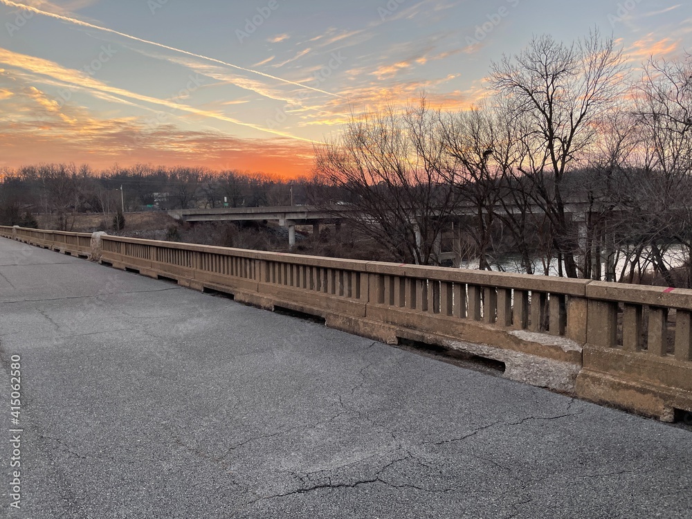 Naklejka premium sunset over abandoned bridge