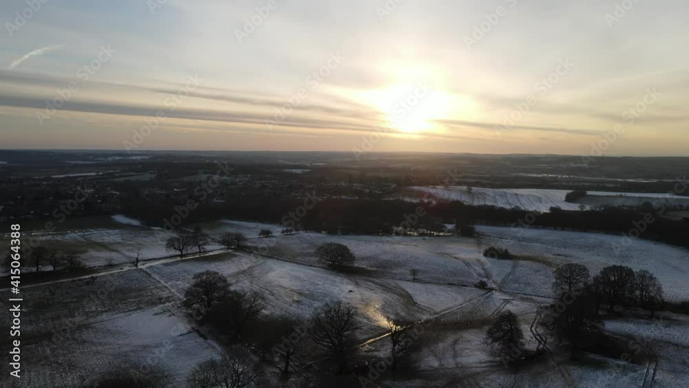 Sunrise over frozen fields in winter England aerial pan Sunrise over frozen fields in winter England aerial pan