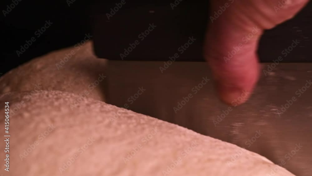 Fresh dough being cut to slices before baking Fresh dough being cut to slices before baking