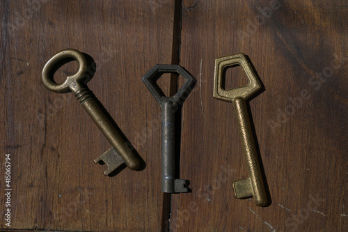 Set of old door keys on wood. © Eric