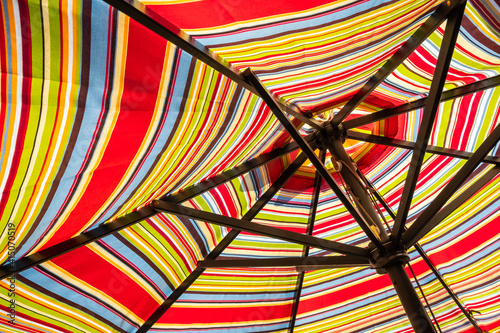 Obraz na płótnie Abstract background with stripes...striped patio umbrella from the underside in the sun. w salonie
