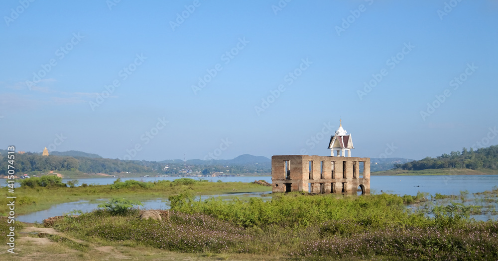 Wat Wang Wiwekaram, the old temple underwater, one of landmark of Sangklaburi. Thailand with blue sky and beautiful landscapr of Songkaria river. Wat Wang Wiwekaram, the old temple underwater, one of landmark of Sangklaburi. Thailand with blue sky and beautiful landscapr of Songkaria river.