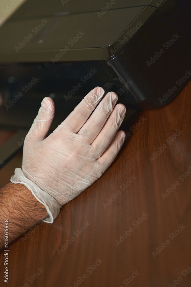 man's hands check an inkjet printer. Printer technician