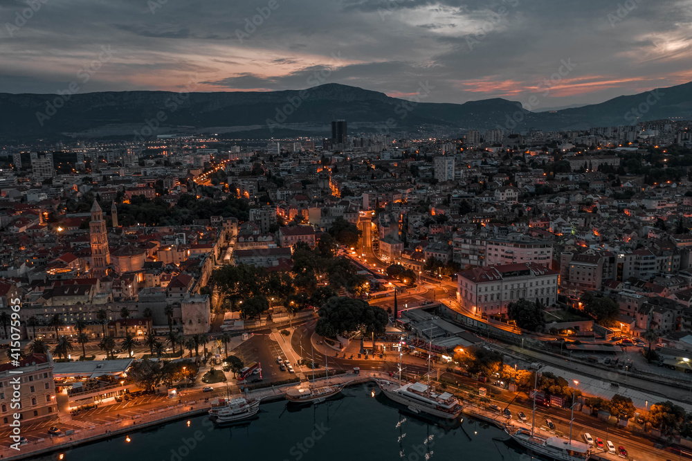 Aerial drone shot of west Diocletian Palace at dusk in Split old towni with lights before sunrise in Croatia