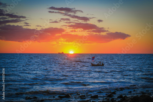 Orange afternoon landscape with boat