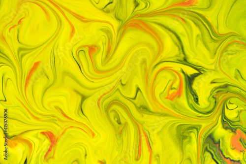Watercolor natural background from streaks of yellow, green and red paint close-up. Sprayed liquid textured paint for wallpaper, cards and invitations. Watercolor stains.