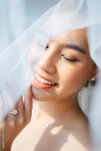 Happy bride under the veil.