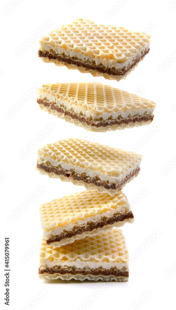 Levitating waffles are isolated on a white background. Delicious crisp waffles. Levitating waffles are isolated on a white background. Delicious crisp waffles.