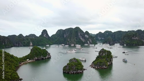 A magnificient island landscape in Vietnam with a lot of tourist boats photo