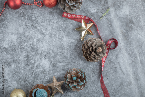 Oak cones with red and golden ornaments and a Christmas style ribbon