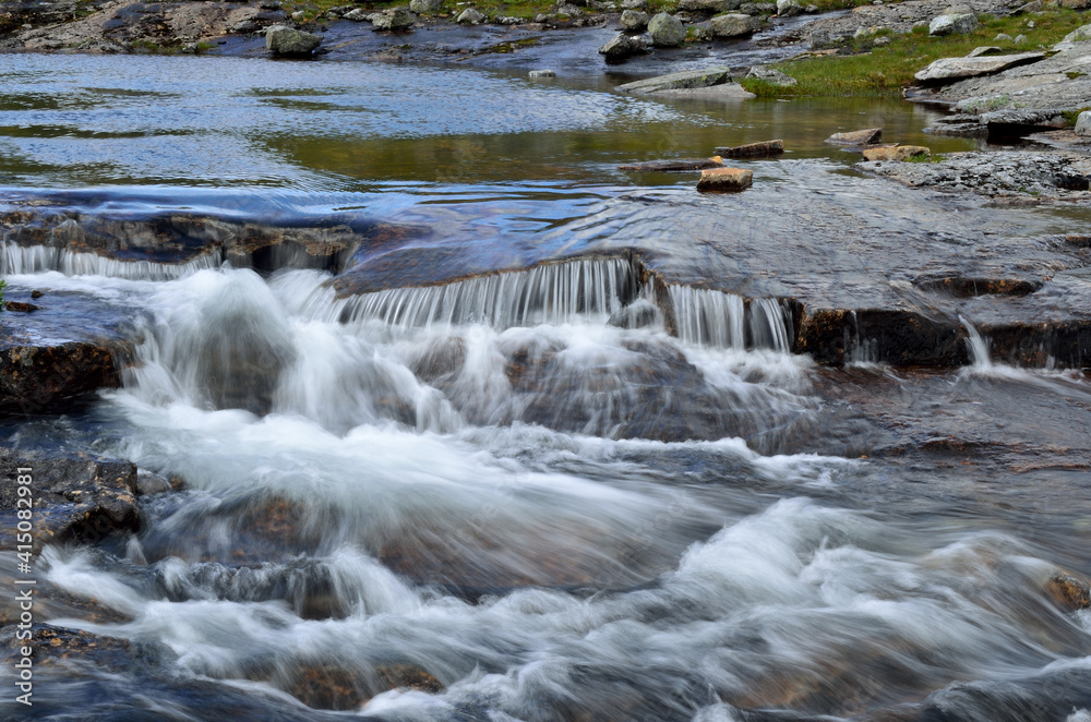 calm mountain lake with serene creek and waterfall calm mountain lake with serene creek and waterfall