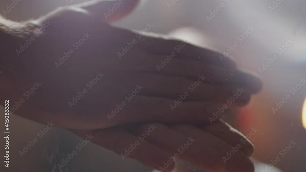 A man wipes his hands with dust for grip