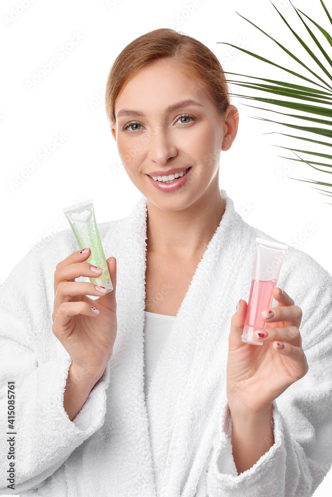 Beautiful young woman with cosmetic products and tropical leaf on white background, closeup Beautiful young woman with cosmetic products and tropical leaf on white background, closeup