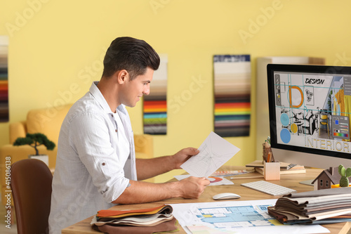 Male interior designer working in his office