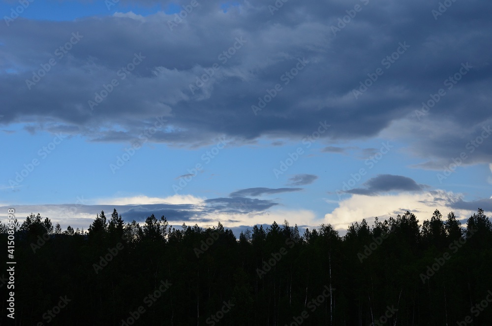 summer thunder storm clouds brewing over forest and mountain landscape summer thunder storm clouds brewing over forest and mountain landscape