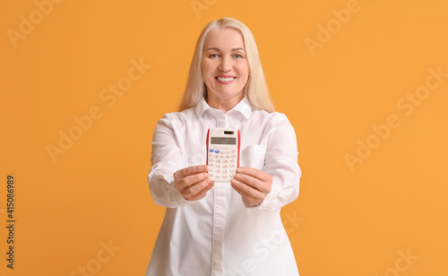 Mature woman with calculato...
