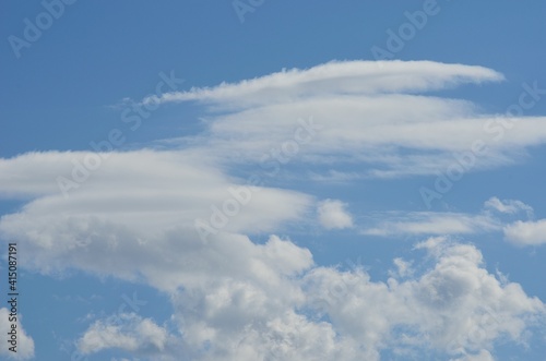 white cloud shapes on blue summer sky