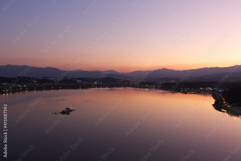 Peaceful lake view at sunrise.