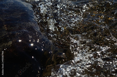 Fototapeta Naklejka Na Ścianę i Meble -  beautiful clean water river flow with air bubbles closeup 