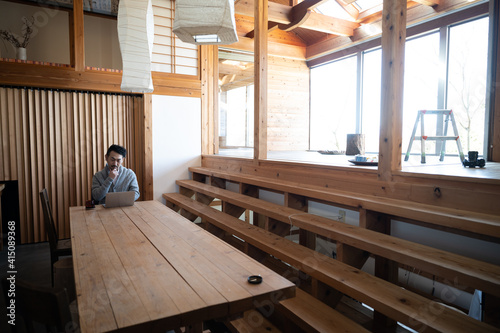 A man working remotely in a large, stylish place with a copy space.