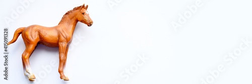Figurine of a horse toy on white background. banner