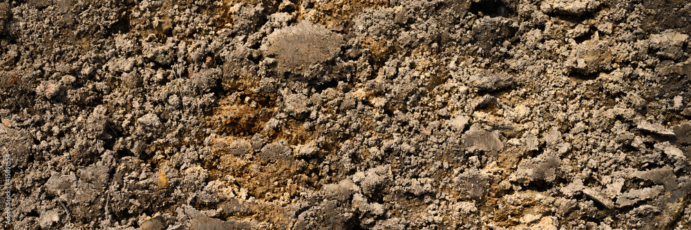 background texture from the loose surface of the sand and earth soil. top view. banner