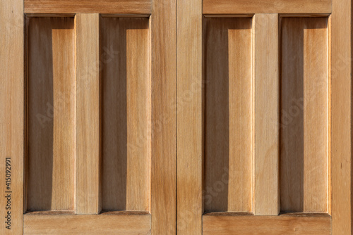 Detail of a Japanese wooden door used in a temple illuminated by a beautiful sunlight.