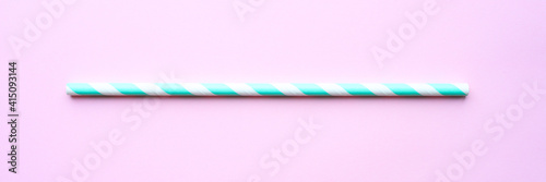 one paper striped white and green drinking straw for party on pink background. space for text. banner