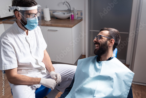 Male patient consults with his dentist