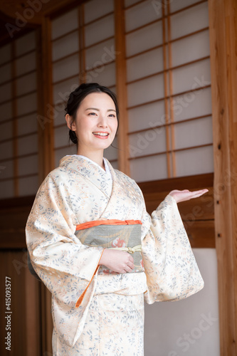 Vertical image of a beautiful young landlady, easy to use as a banner material for travel and inns. omotenashi, photo