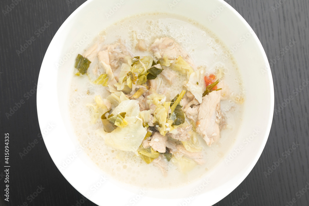 Tom Kha Gai or Thai Coconut Chicken Soup in white bowl isolated on black backdrop. Tom Kha Gai or Thai Coconut Chicken Soup in white bowl isolated on black backdrop.