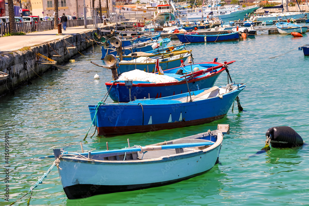 Italy, Apulia, Metropolitan City of Bari, Molfetta. Row boats in harbor.