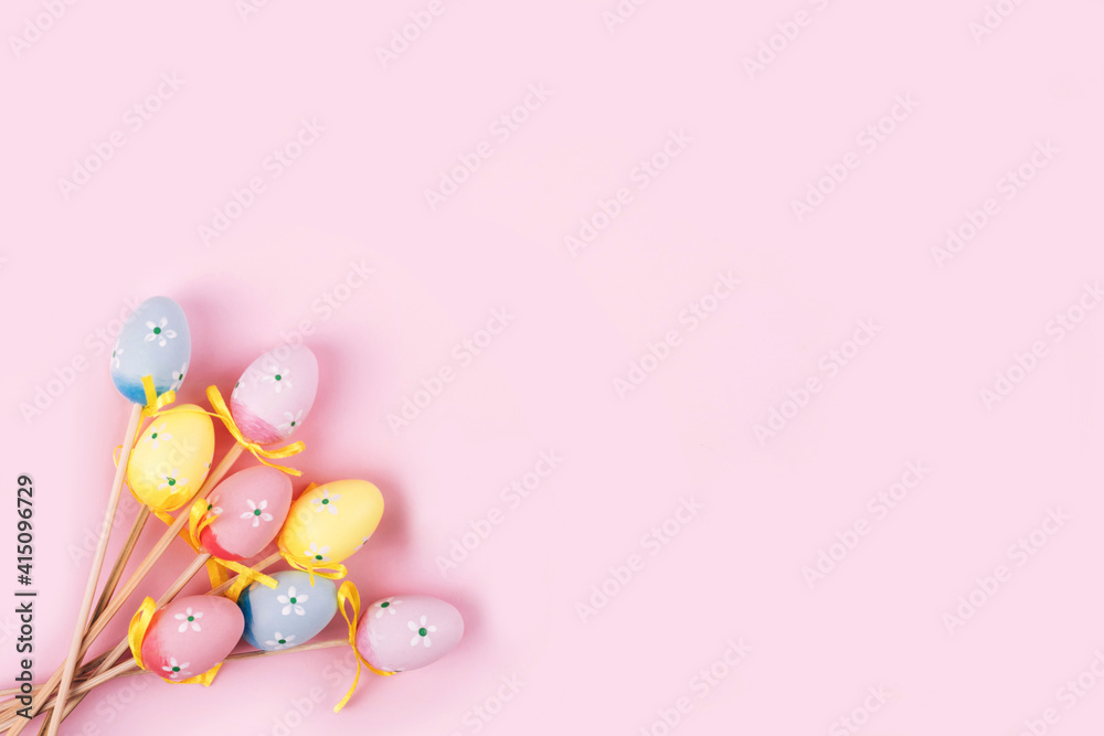 Colorful Easter eggs over pink background.