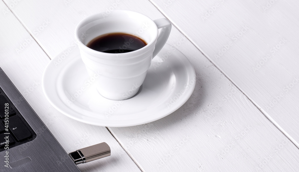 cup of coffee and laptop on the white wooden table cup of coffee and laptop on the white wooden table