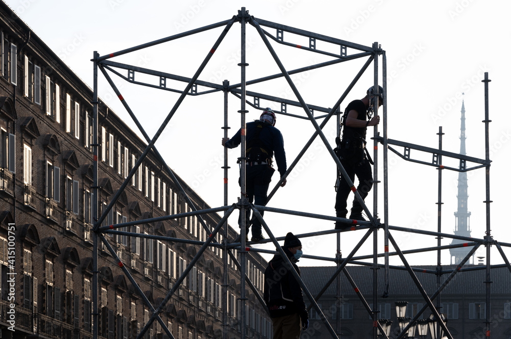 Construction workers assembling a scaffold