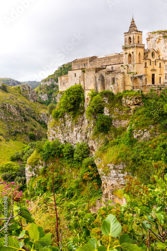 Italy, Basilicata, Province of Matera, Matera. Ravine of Torrente Gravina (Gravina river) and the city of Matera. Chiesa di San Pietro Caveoso at right.