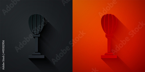 Paper cut Punching bag icon isolated on black and red background. Paper art style. Vector.