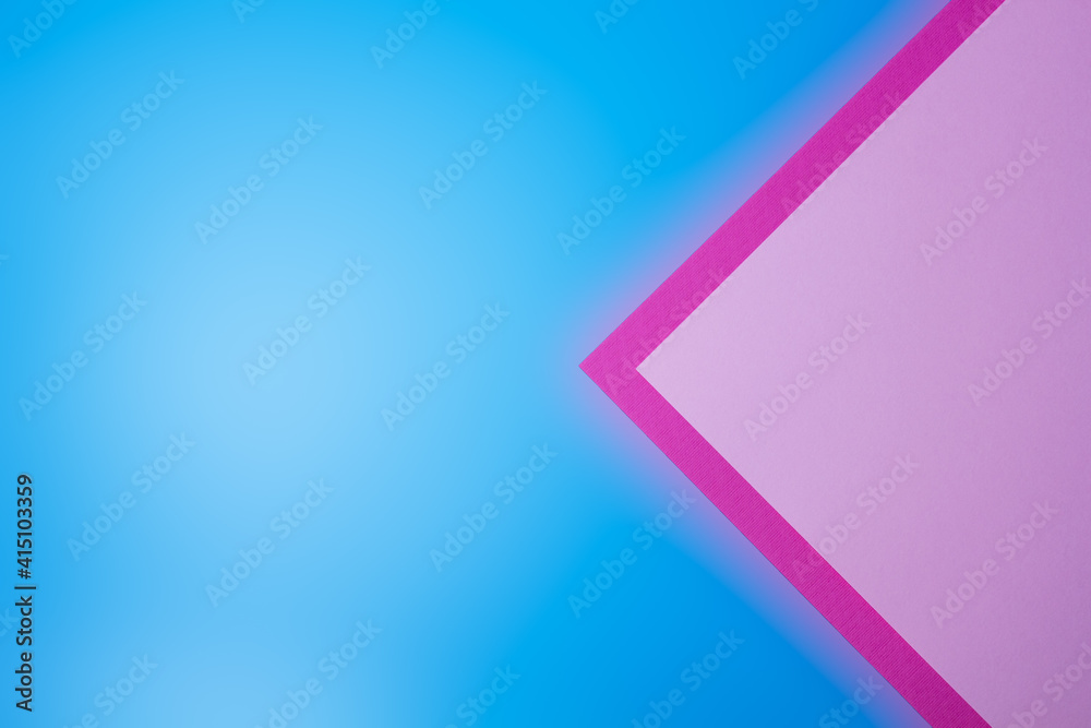 Pink colored textured paper on a blue background