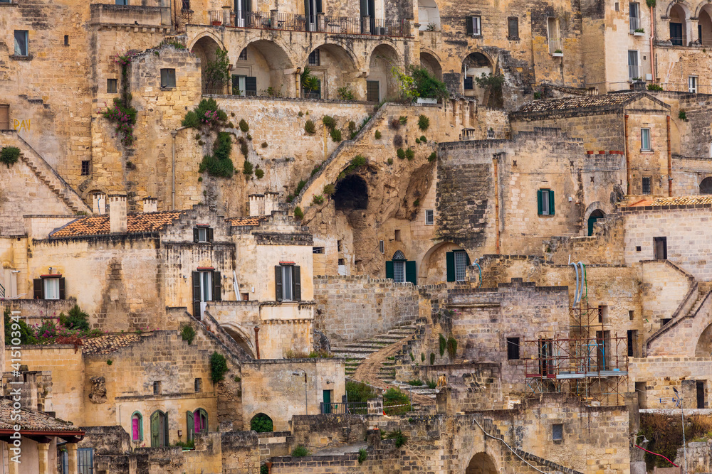 Italy, Basilicata, Province of Matera, Matera. Old stone buildings on a steep hillside.