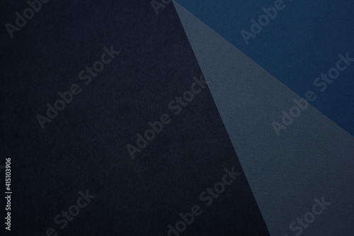 Dark background with black gray blue textured paper