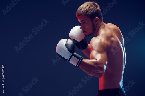 shirtless boxer with gloves on dark background. Isolate